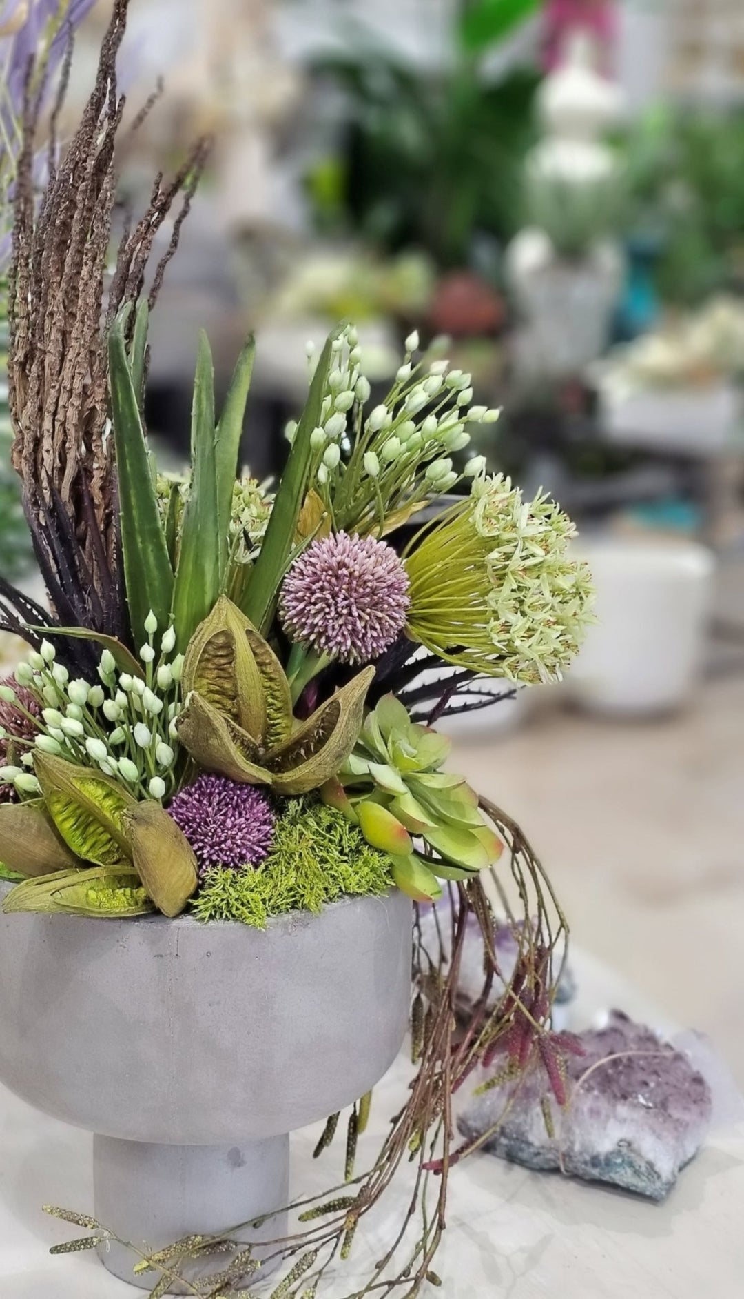 Allium, Agapanthus, Aloe, Succulents, Sora Pods, Hanging Vine, and Coco Jhar in Bowl. FH: 31"H - LDF Silk