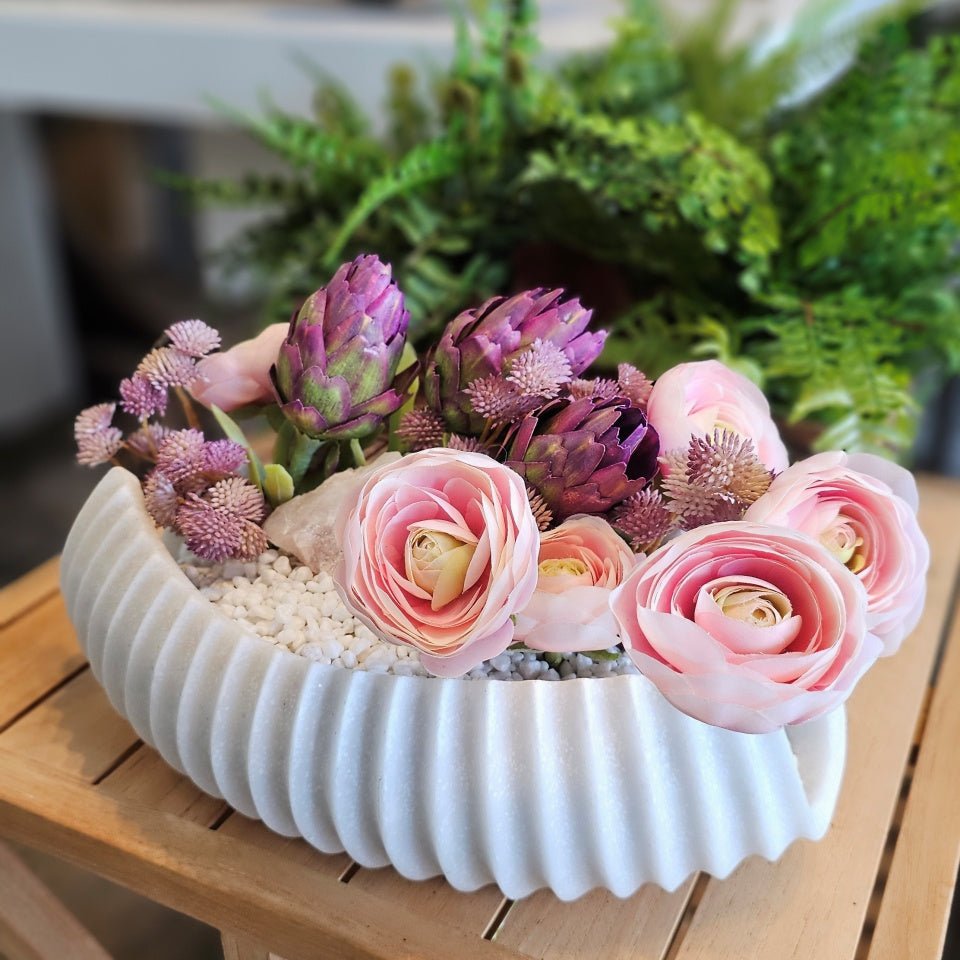 Protea, Ranunculus, and Mini Flowers with Pink Rock in Carved Stone Oval Bowl 7.5"H - LDF Silk